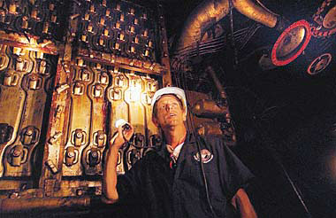 Danny Harris, an electrician with the James River Reserve Fleet, looks around the boiler room of the Gage, an attack transport ship that took Marines across the Pacific and landed them on Okinawa during World War II.

 
 
 
 

